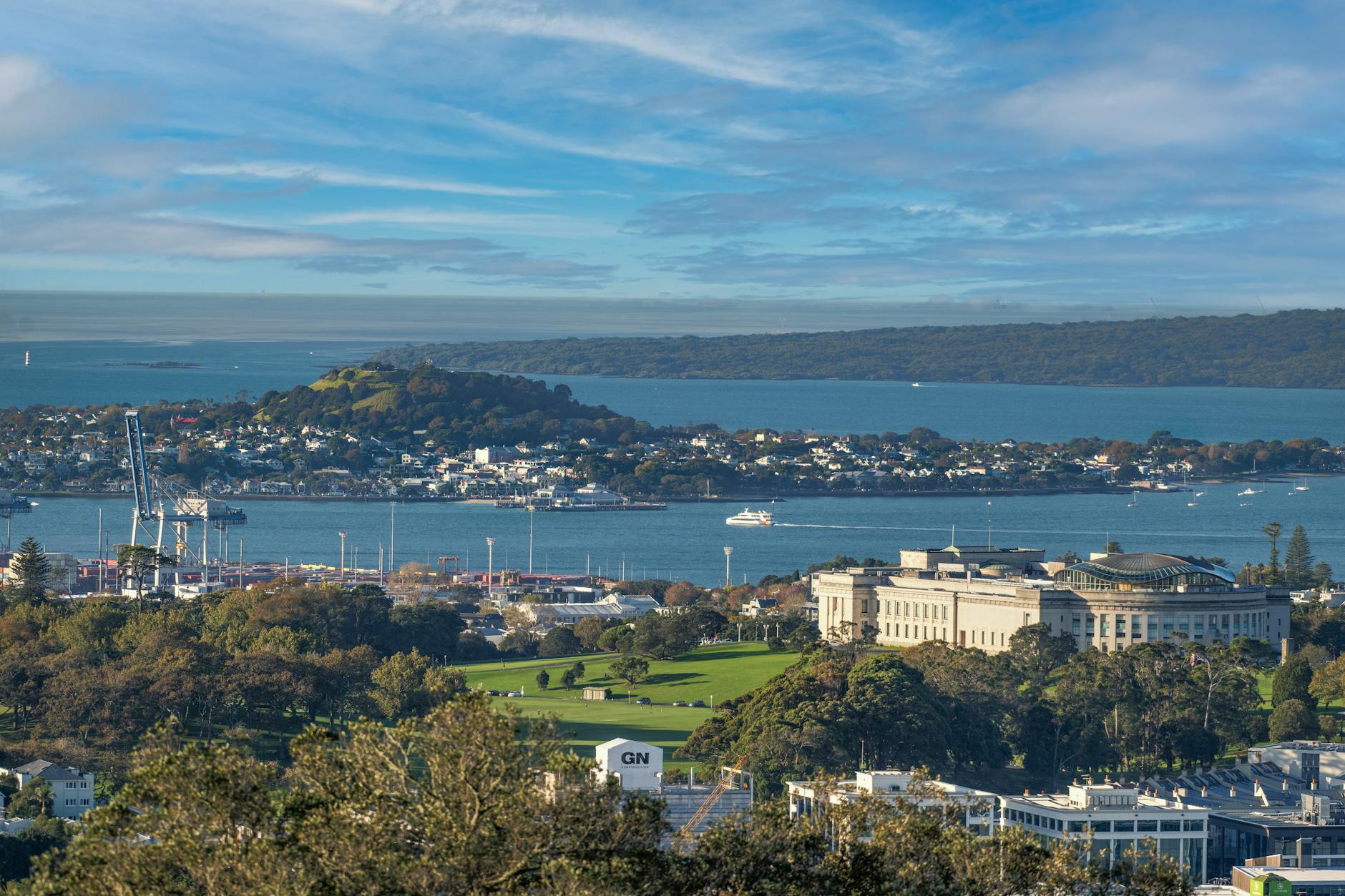 Scenic view of Auckland Museum, harbor, and city skyline on a clear day.