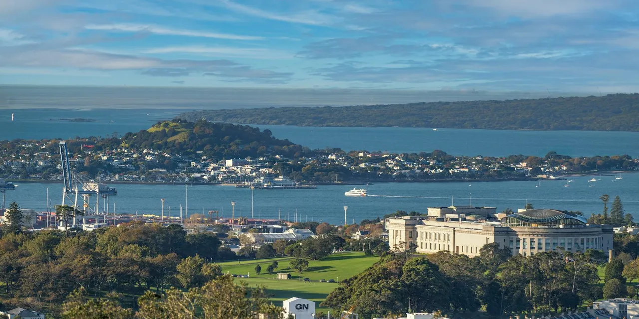 Scenic view of Auckland Museum, harbor, and city skyline on a clear day.