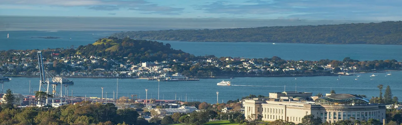 Scenic view of Auckland Museum, harbor, and city skyline on a clear day.
