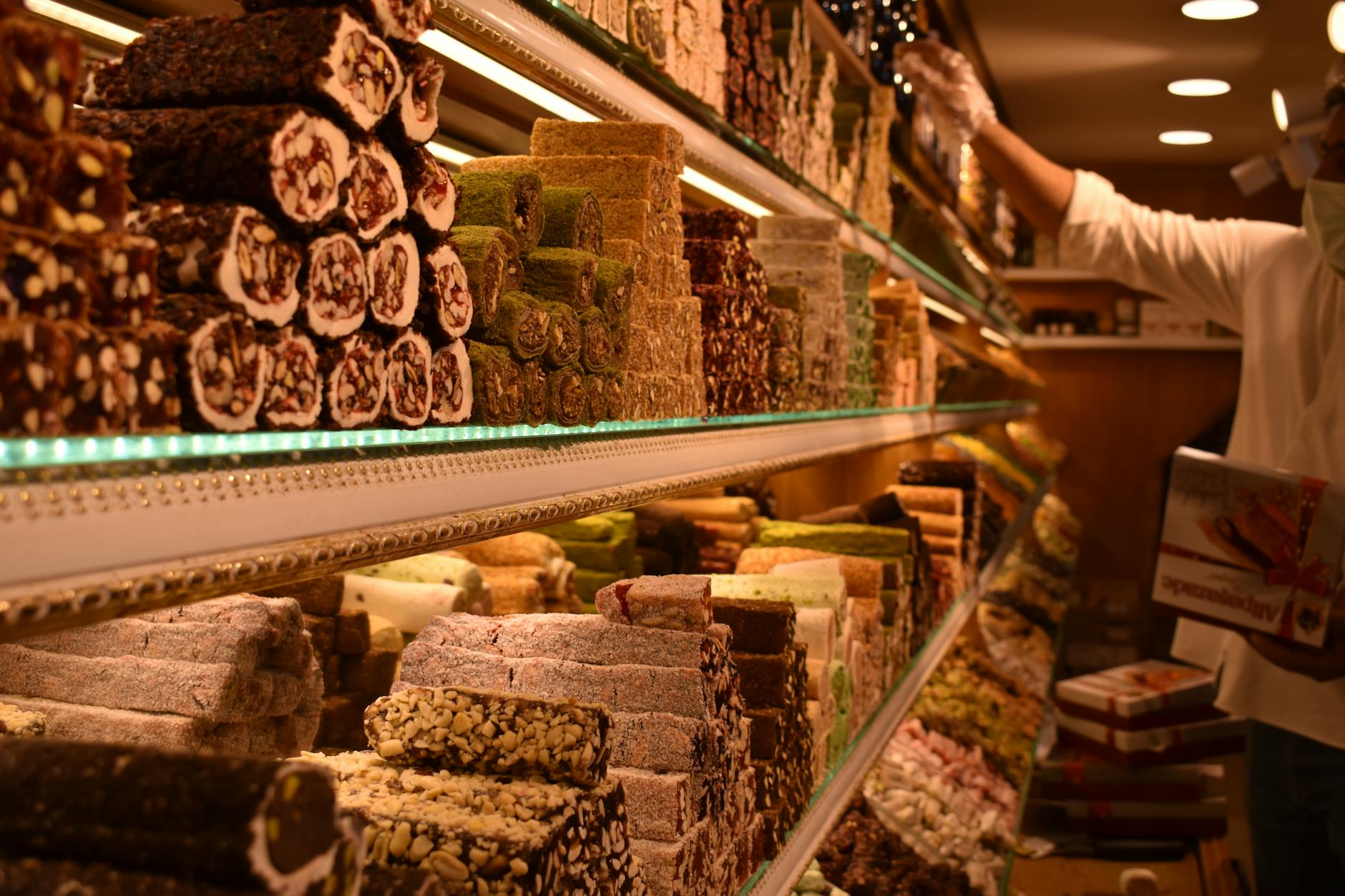 Explore shelves filled with colorful Turkish delights in a bustling Istanbul market.