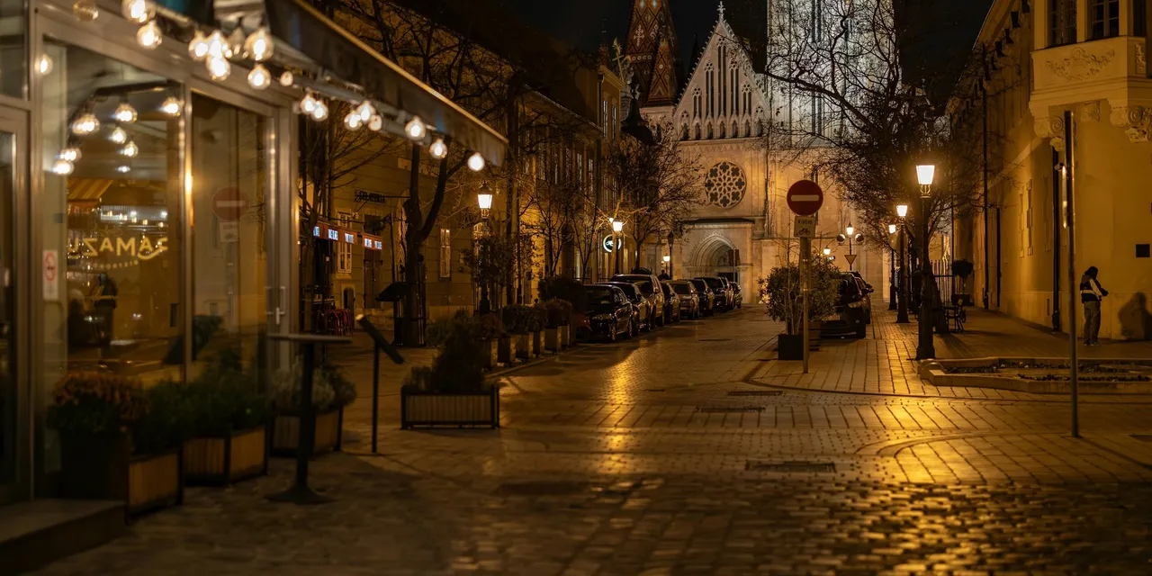 Budapest cobblestone street at night with Matthias Church illuminated, Hungary