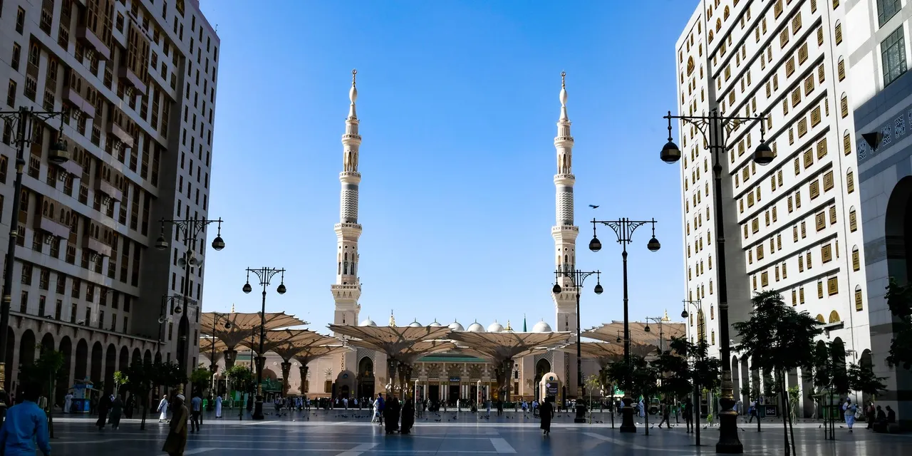 The stunning architecture of Al-Masjid an-Nabawi mosque with its iconic minarets in Medina, Saudi Arabia.