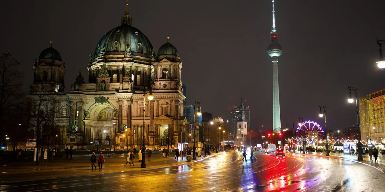 A captivating night scene featuring Berlin Cathedral and Fernsehturm illuminated in Berlin, Germany.