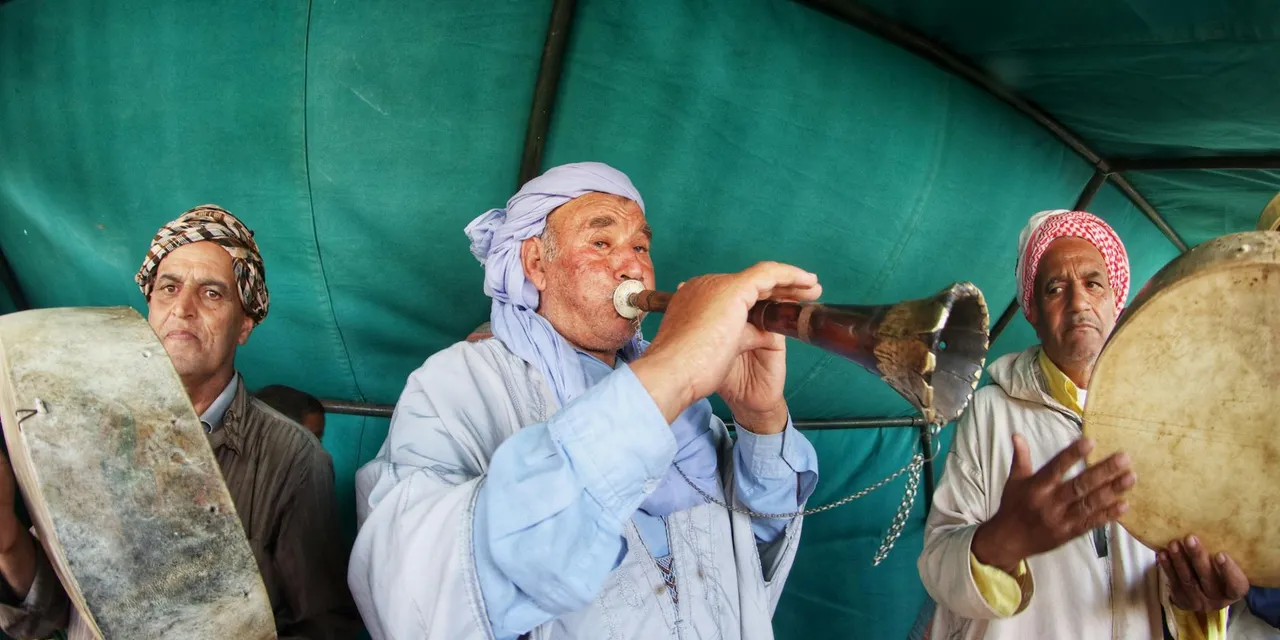 Musicians performing traditional Algerian music in a tent in Algiers.