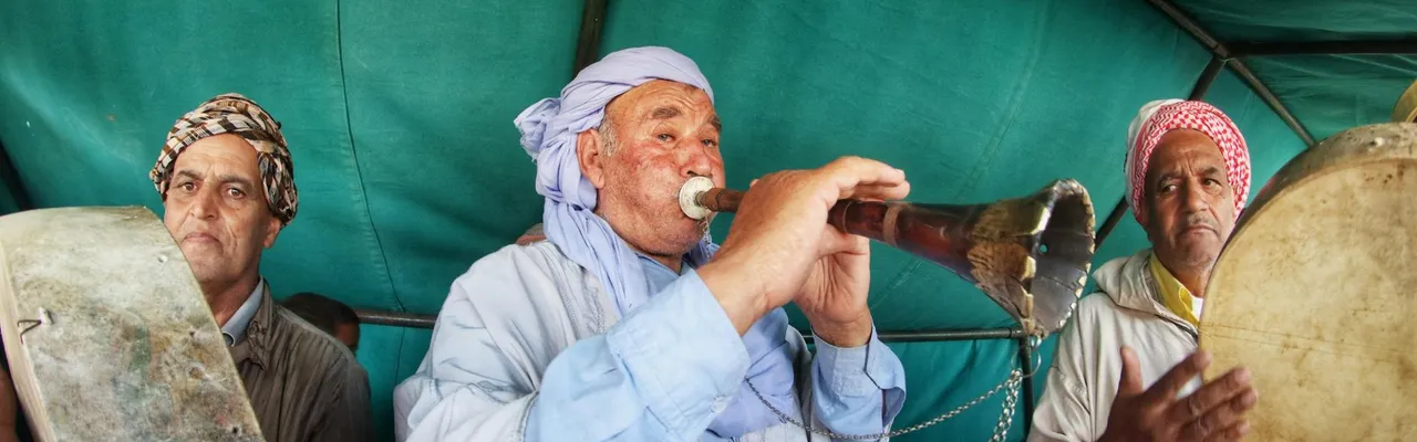 Musicians performing traditional Algerian music in a tent in Algiers.