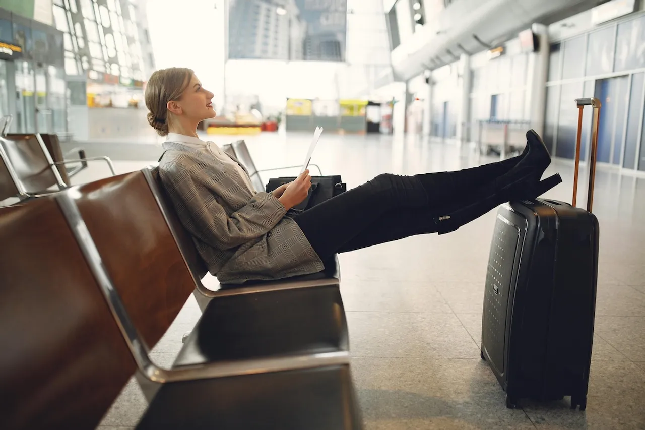 Woman with IBD relaxed in the airport before boarding flight