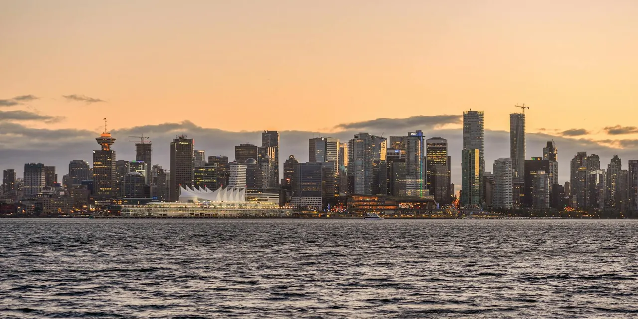 Stunning view of Vancouver's downtown skyline with waterfront and sunset glow.