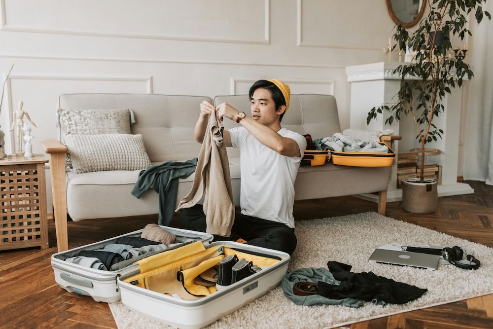 Man travelling abroad with ADHD medication is packing his suitcase