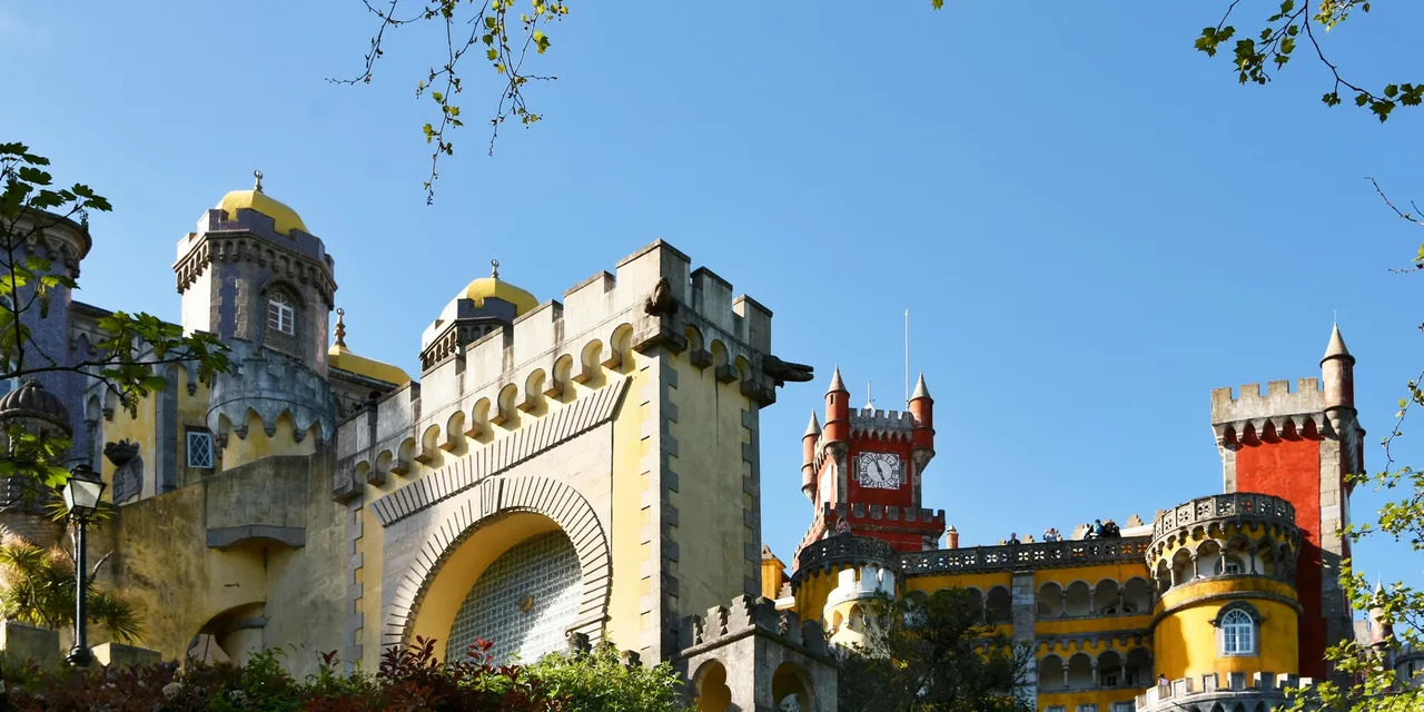 Colourful towers of Pena Palace in Sintra under a blue sky, Portugal