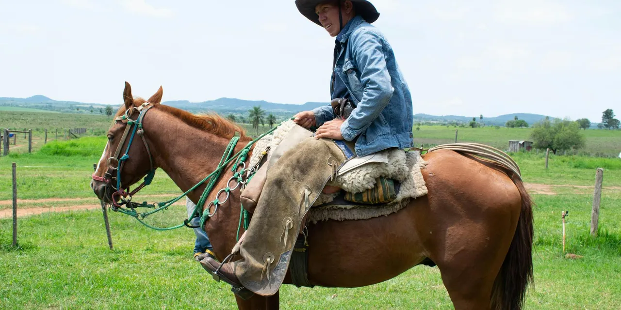 A Paraguayan cowboy on horseback in Misiones countryside, portraying rural life and tradition.