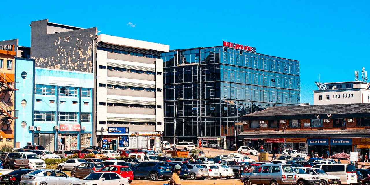Vibrant urban scene with busy traffic in Matsapha, Eswatini featuring commercial buildings under a clear sky.