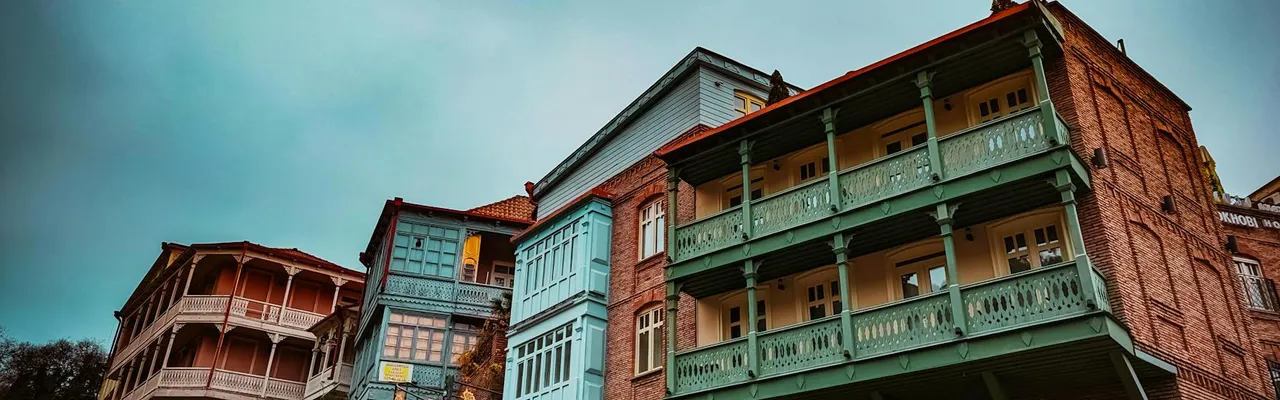 Explore the vintage charm of colorful wooden balconies on historic buildings in Tbilisi, Georgia.