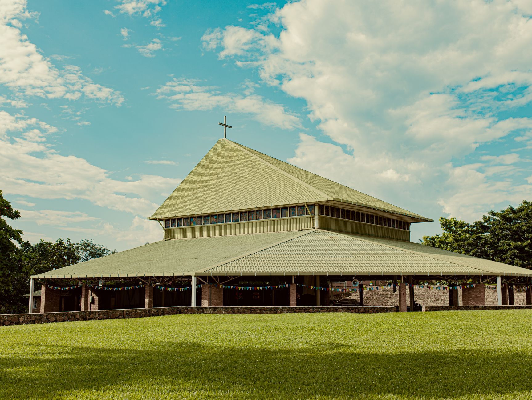 Beautiful modern church architecture surrounded by lush greenery in Bujumbura, Burundi.