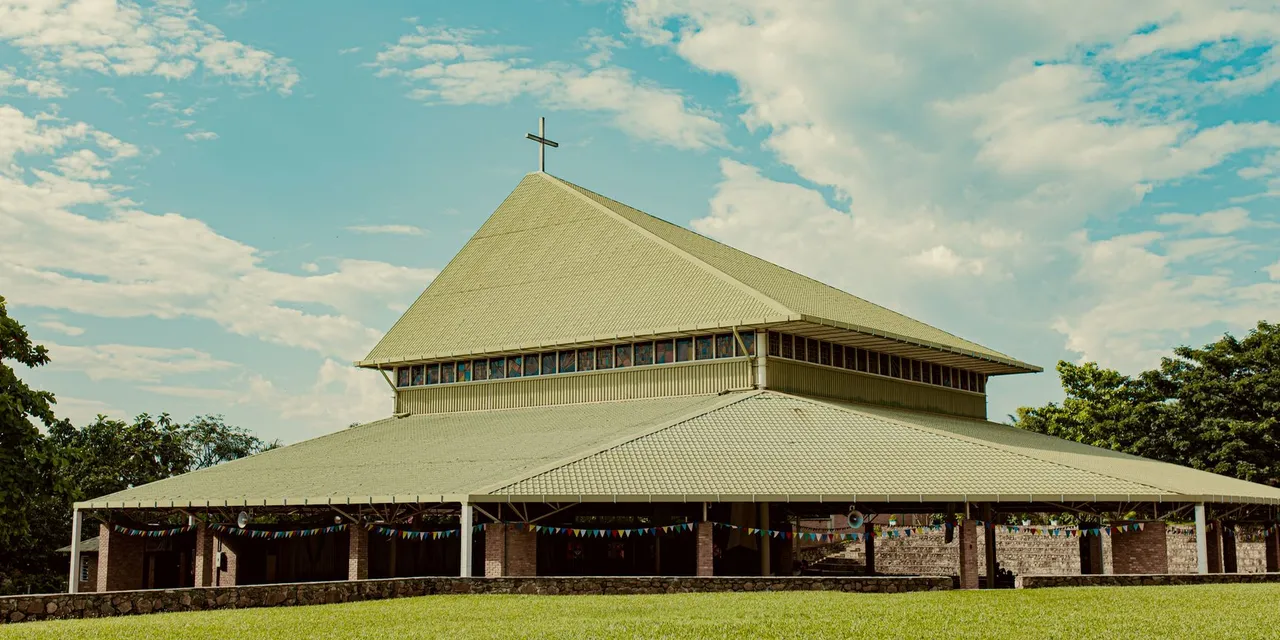Beautiful modern church architecture surrounded by lush greenery in Bujumbura, Burundi.