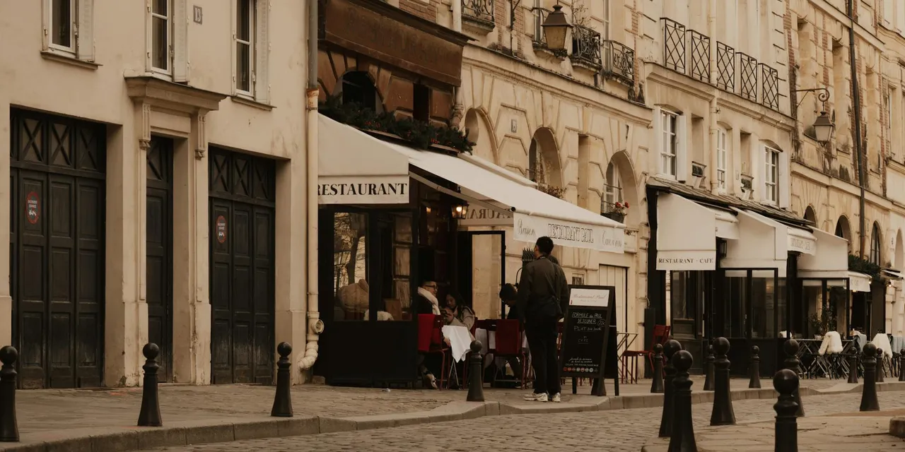 Cobblestone street in Paris with cafes and classic architecture, evoking a vintage urban mood.