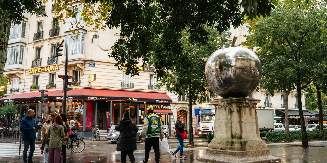 A vibrant Paris street scene featuring a cafe, sculpture, and people.