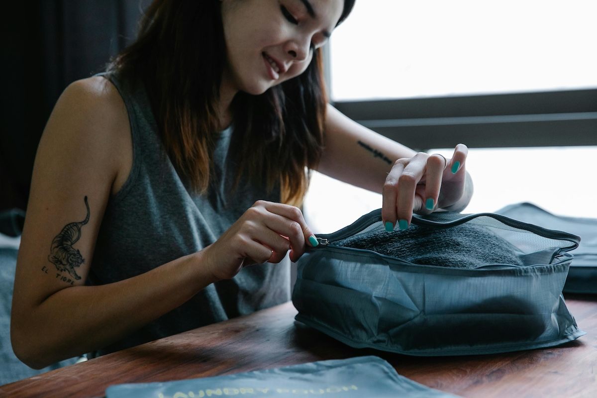 Woman with IBD packing her medication for travelling abroad