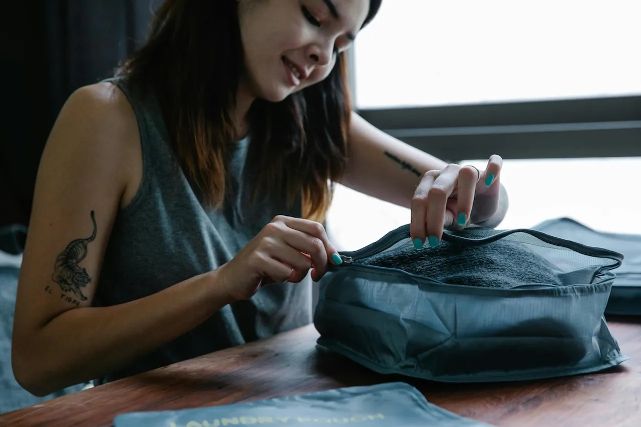 Woman with IBD packing her medication for travelling abroad