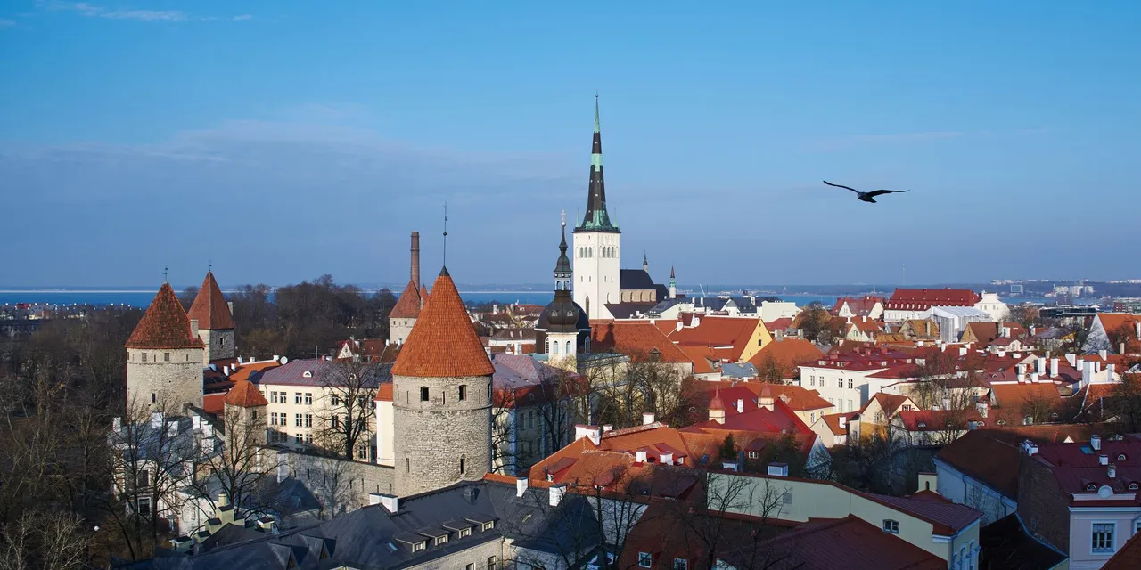 A picturesque aerial view of Tallinn's historic old town with iconic red roofs and church spires.