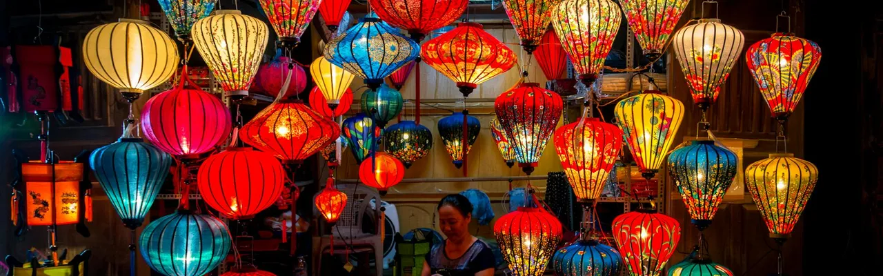 Vibrant silk lanterns hanging in a Hanoi night market, showcasing traditional Vietnamese craftsmanship.