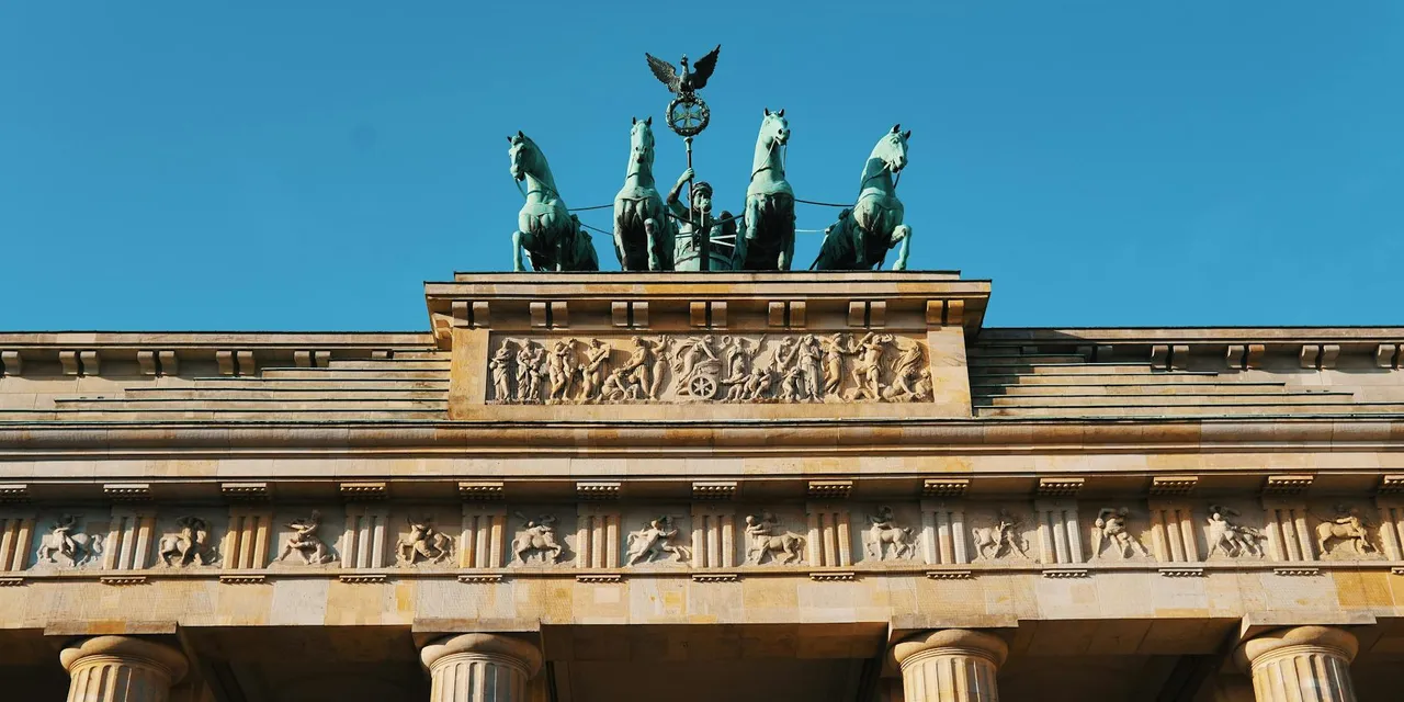 Close-up of the iconic Brandenburg Gate's architecture and sculptures in Berlin, Germany.