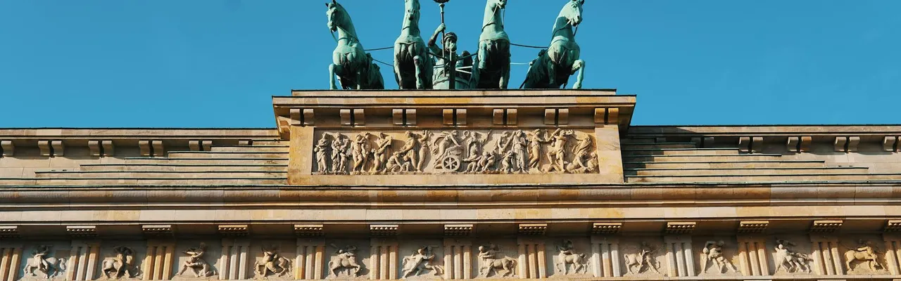 Close-up of the iconic Brandenburg Gate's architecture and sculptures in Berlin, Germany.
