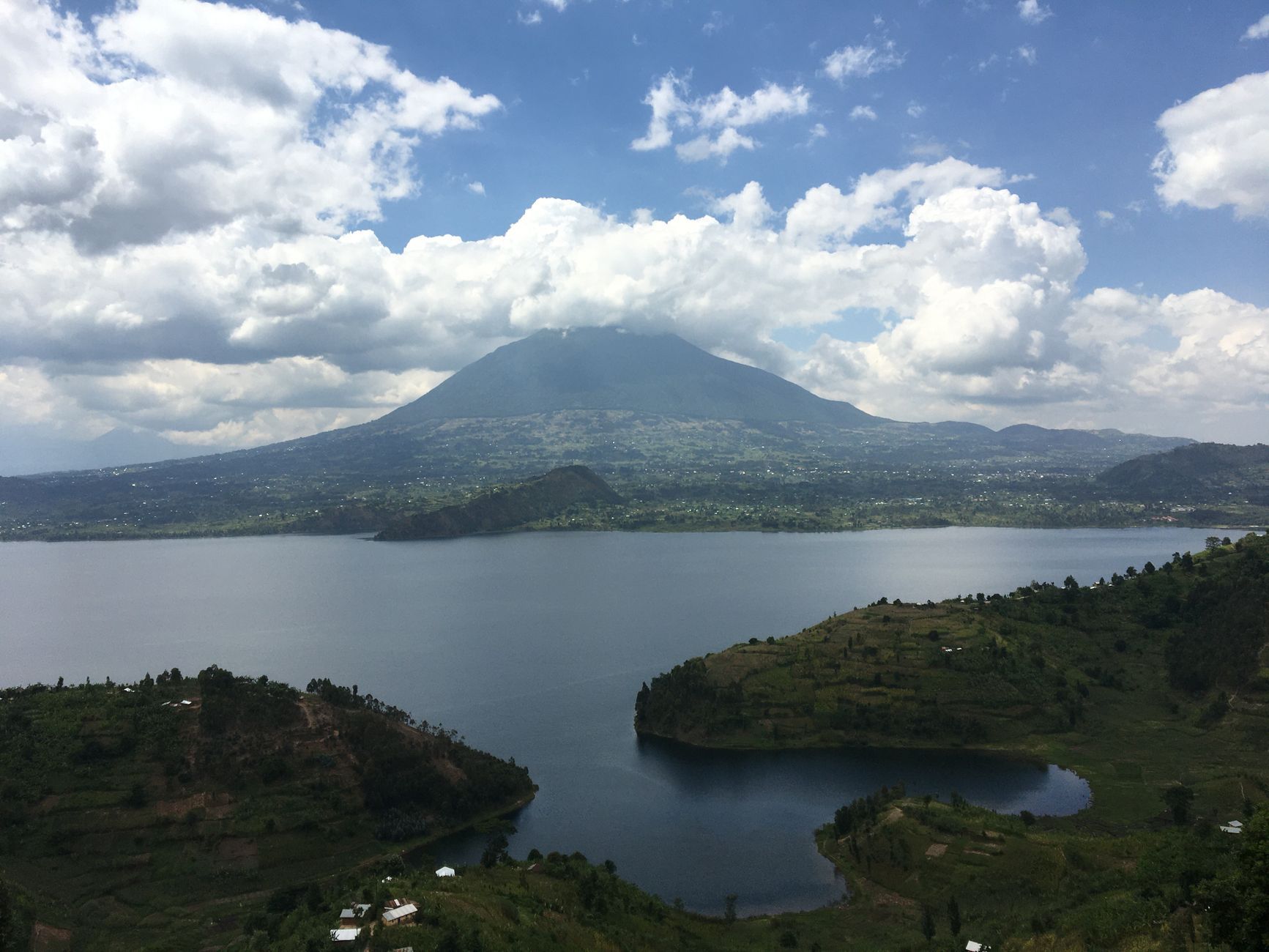 Beautiful landscape of a lake with mountains under a cloudy sky in Butaro, Rwanda.