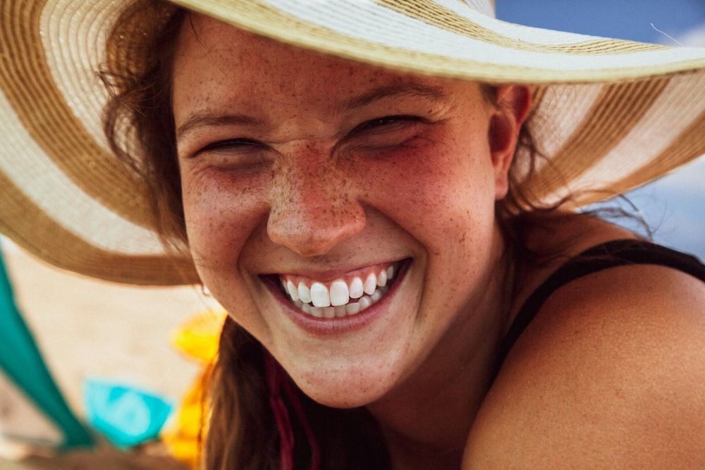 Woman in Spain showing white teeth and smiling, no need for dentist