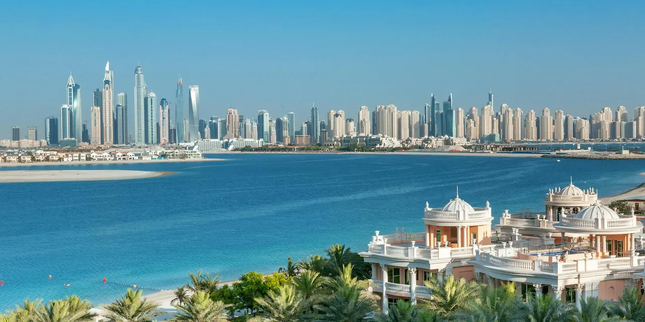 Breathtaking view of Dubai skyline and Palm Jumeirah, showcasing luxury beachfront architecture.