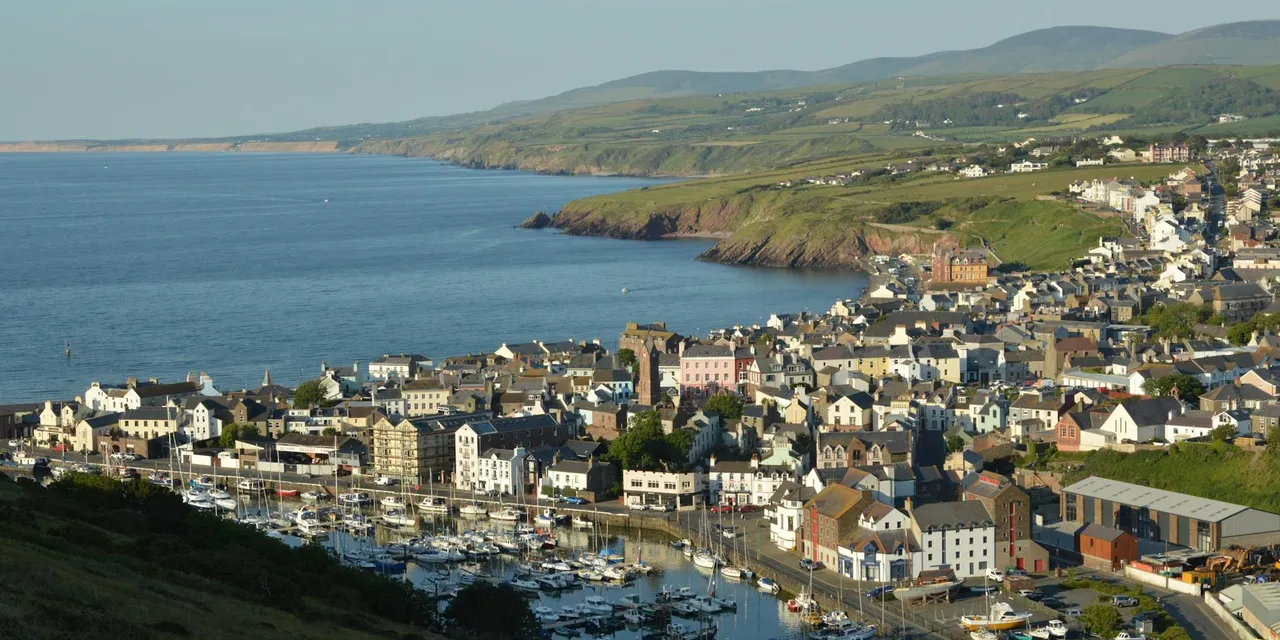 A picturesque view of Peel marina and town on the Isle of Man, showcasing the coastline.