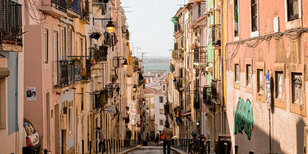 Colorful architecture and cobblestone streets in a charming Lisbon neighborhood.