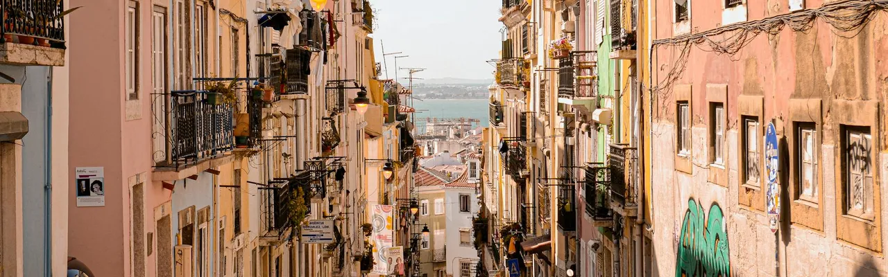 Colorful architecture and cobblestone streets in a charming Lisbon neighborhood.