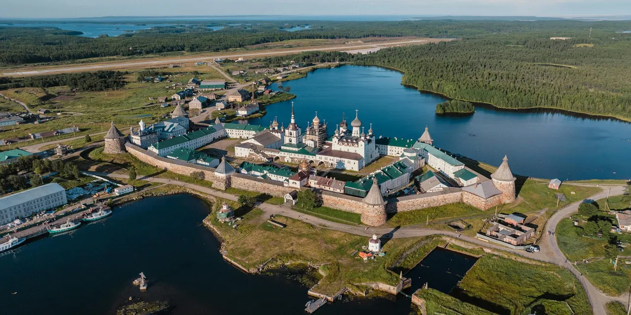 A breathtaking aerial view of Solovetsky Monastery surrounded by serene lakes and lush forests in Russia.