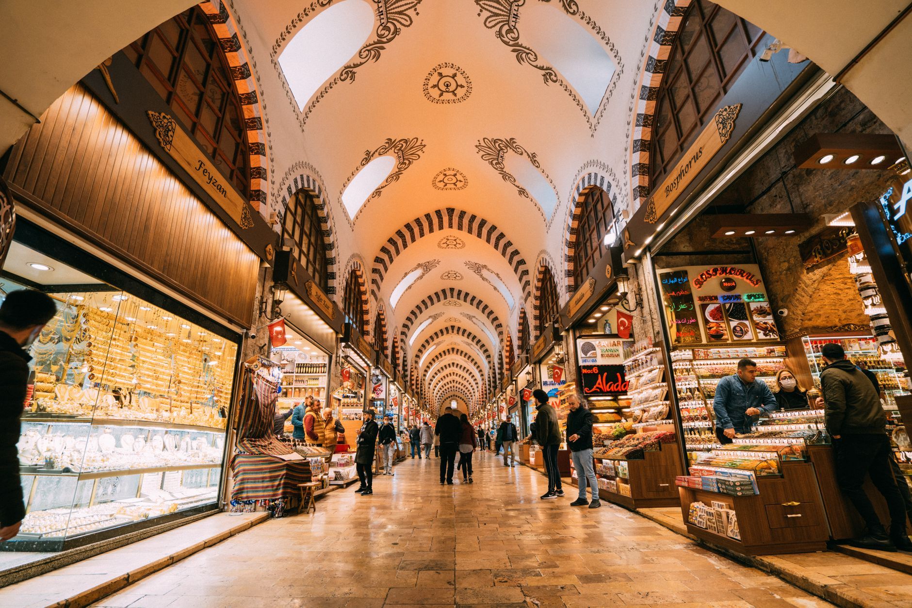 Vibrant scene inside the Grand Bazaar, filled with shops and people exploring traditional goods.