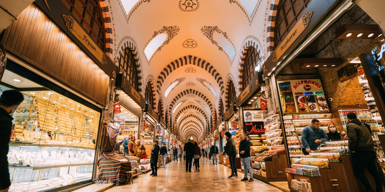 Vibrant scene inside the Grand Bazaar, filled with shops and people exploring traditional goods.