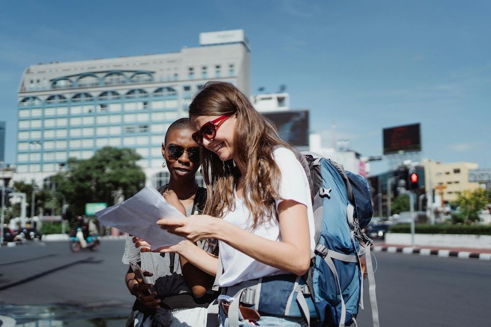 Women with ADHD travelling to Thailand reading map
