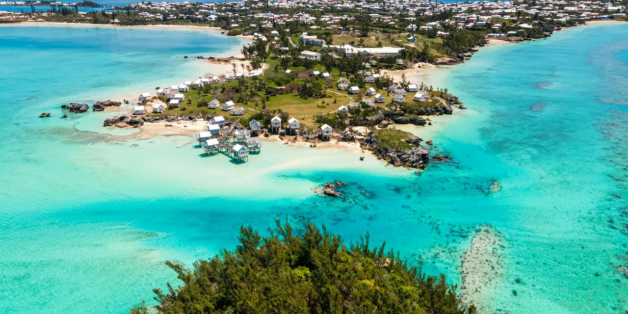 A stunning aerial shot capturing Bermuda's coastline with vibrant turquoise waters and charming houses.