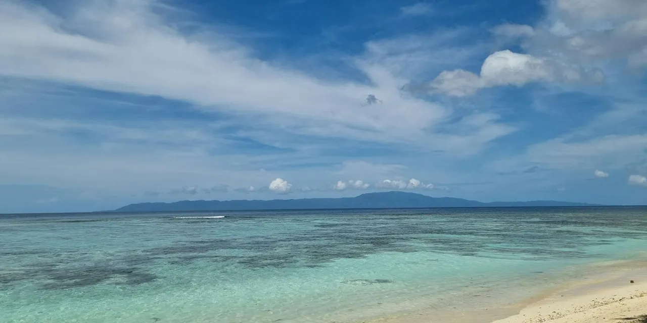 Explore the tranquil beach of Gizo, Solomon Islands with clear waters and sandy shores.
