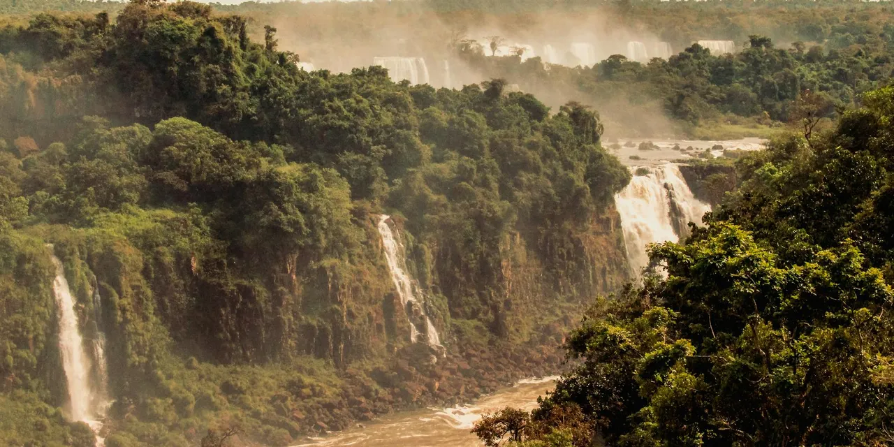 Majestic view of Iguazu Falls set in lush Brazilian rainforest.