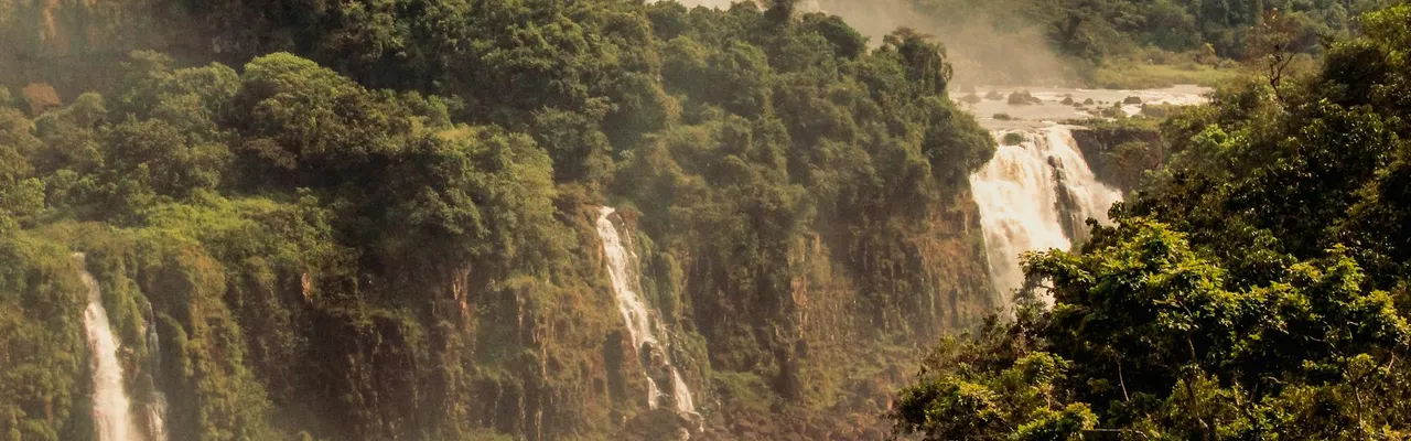Majestic view of Iguazu Falls set in lush Brazilian rainforest.