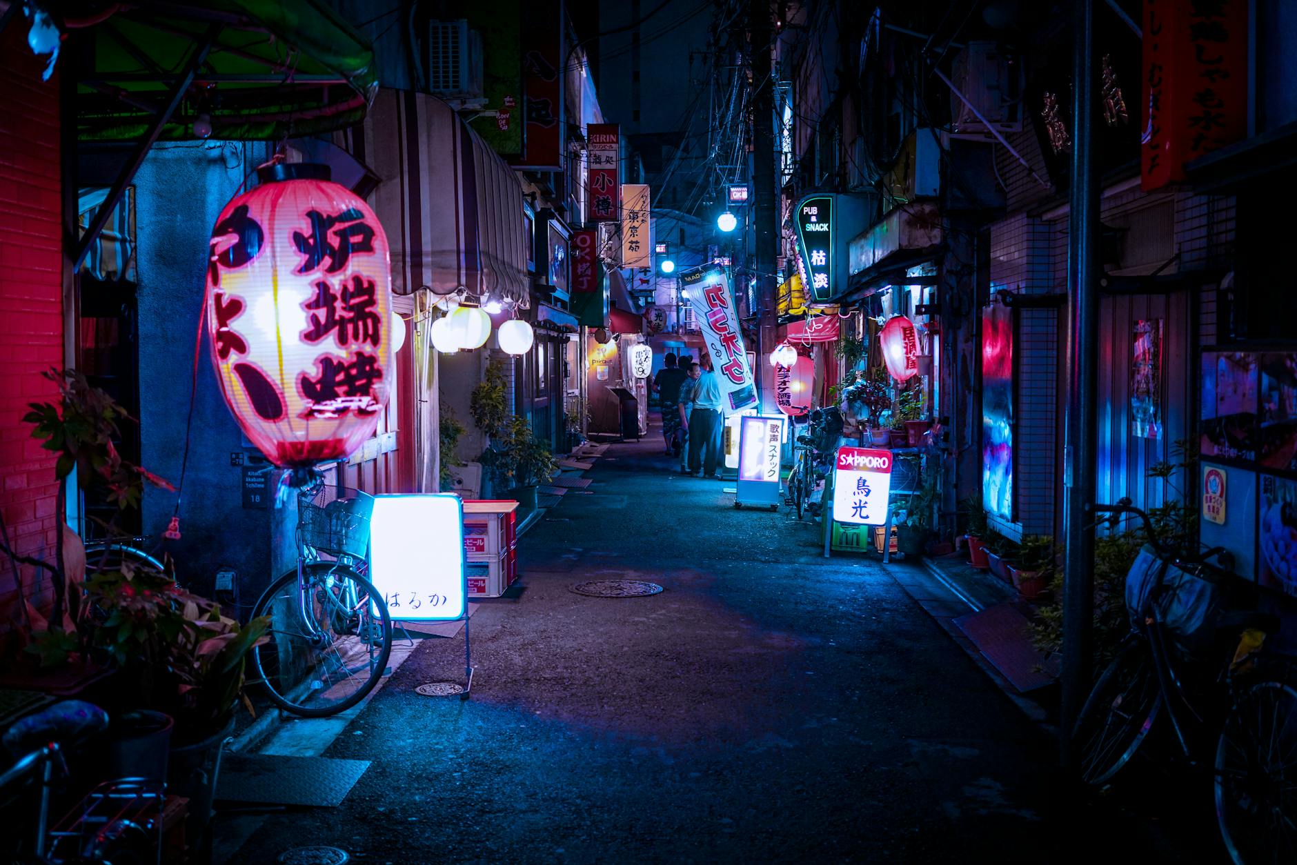 Explore a neon-lit Tokyo alleyway bustling with nightlife, vibrant colors, and cultural charm.