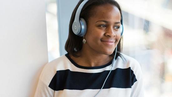 Woman listening to music on headphones