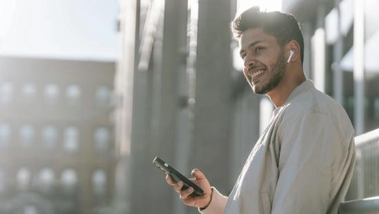 man listening to music on earbuds