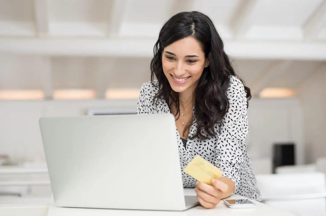 Woman shopping online with a credit card.