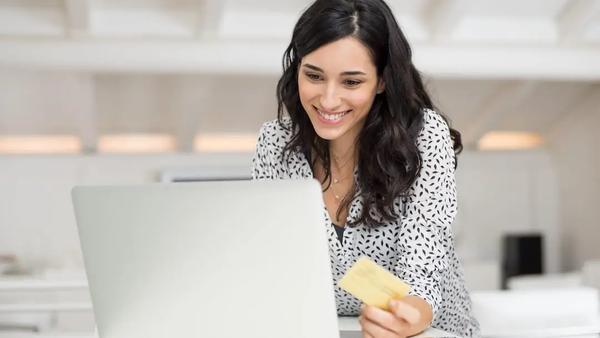 Woman shopping online with a credit card.