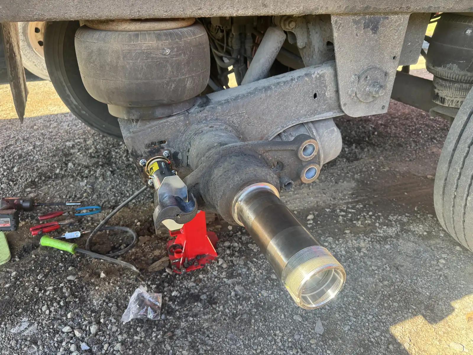 Equipment axle service during truck and heavy equipment service