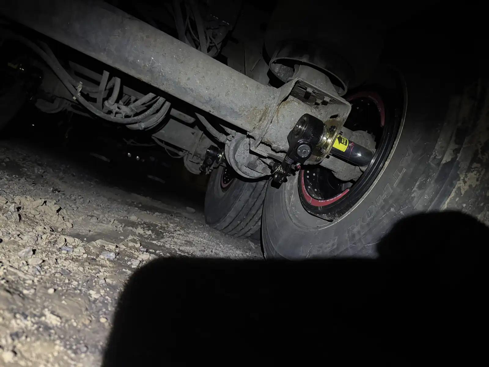 Truck axle at night during truck and heavy equipment service