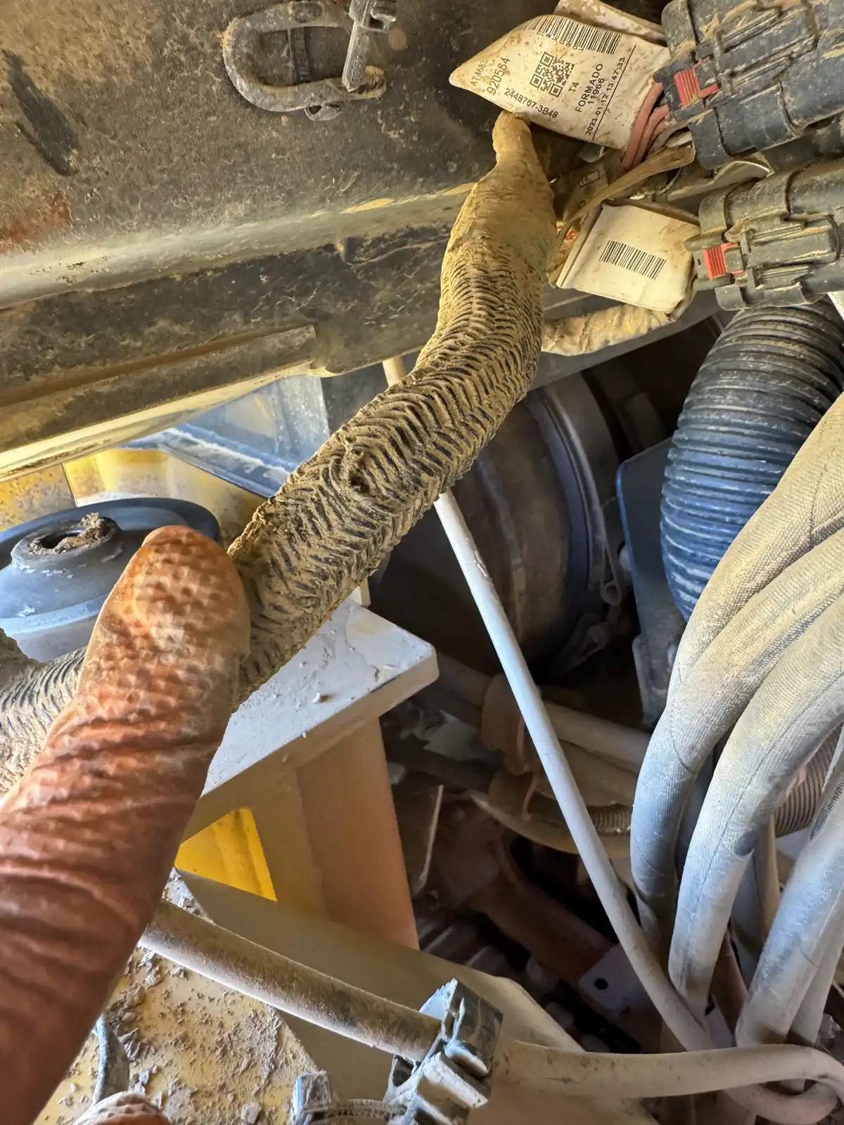 Equipment hoses and wiring during truck and heavy equipment service