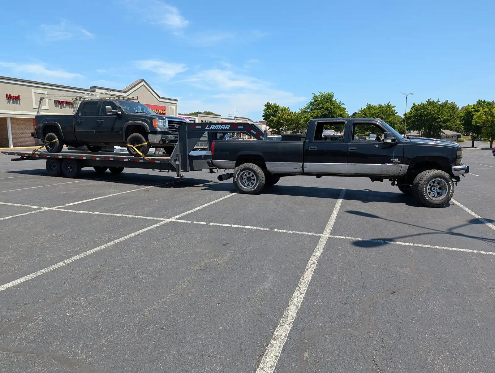 Work truck and trailer during truck and heavy equipment service
