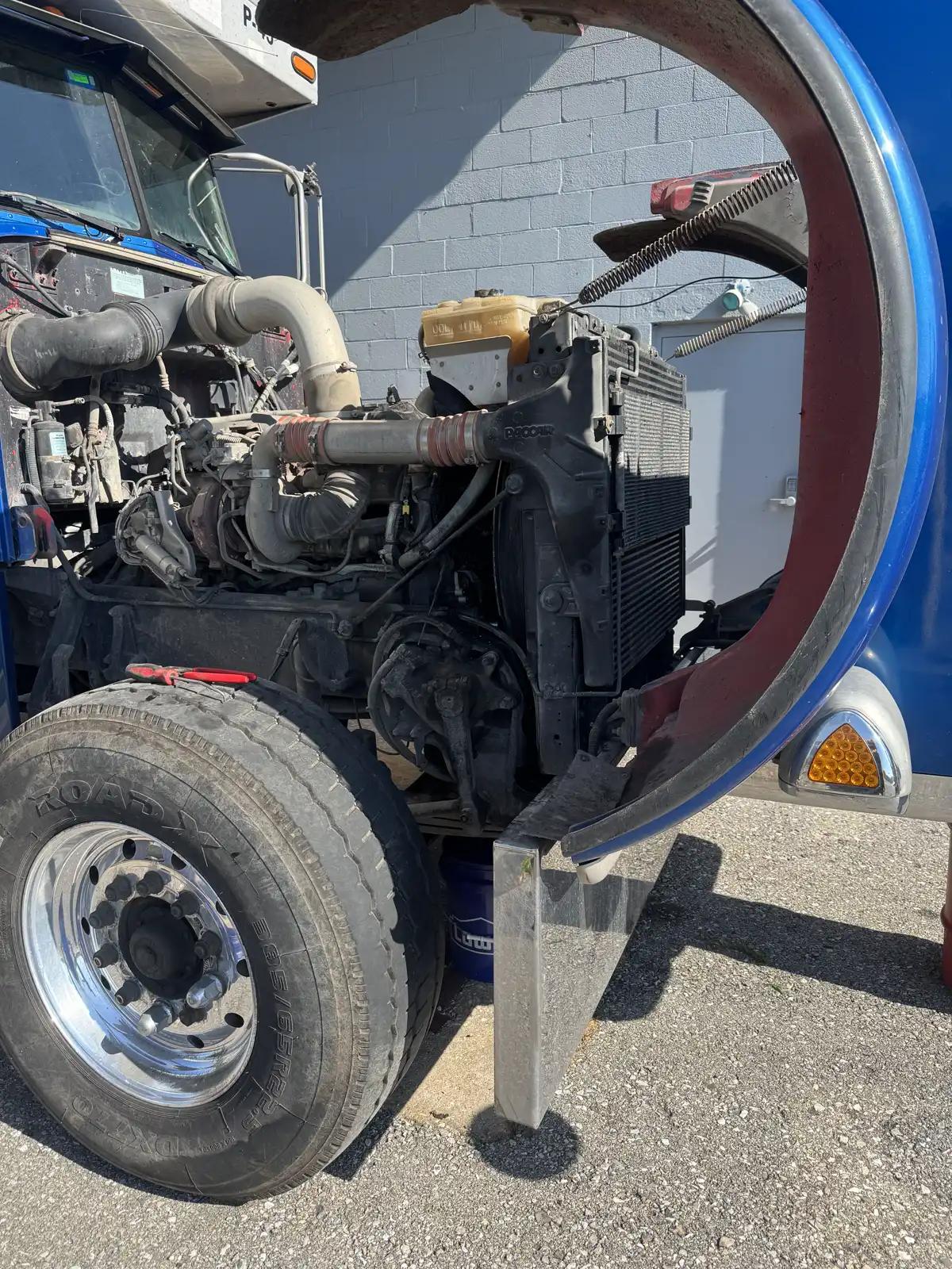 Truck engine with hood open during truck and heavy equipment service